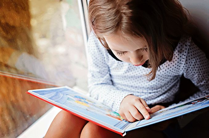 young girl reading a book