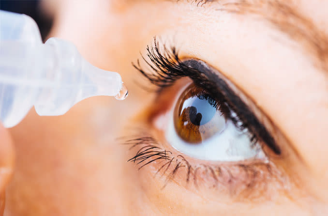 man putting in eye drops