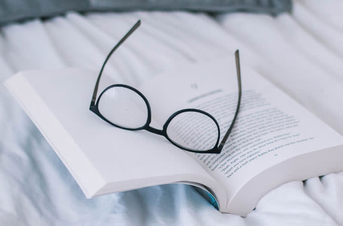 hyperopia eyeglasses on top of a book