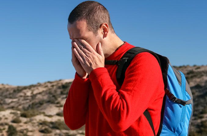 Man rubbing eyes to relieve pain