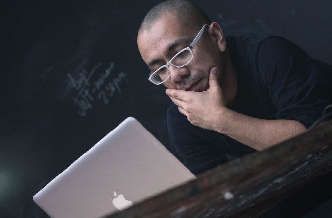 Man working on laptop while wearing glasses