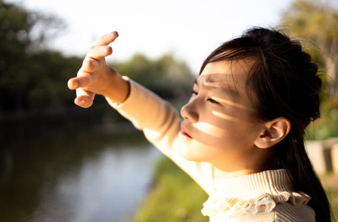 Girl squinting from light sensitivity