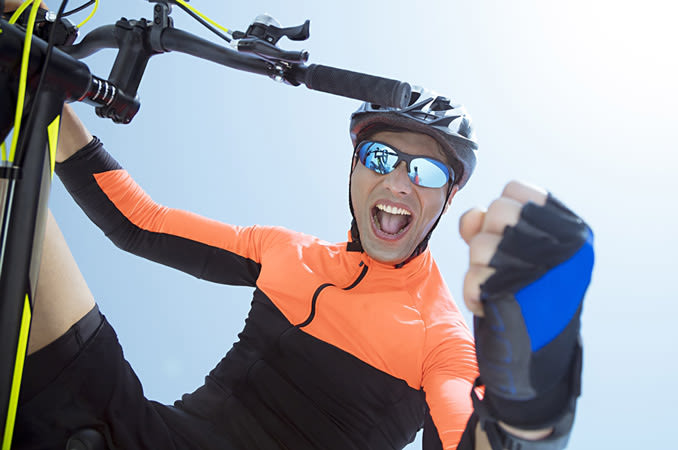 Man riding a bicycle wearing polarized sunglasses. - India